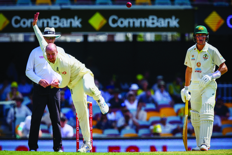 BRISBANE: England's Jack Leach (L) bowls next to Australia's Marnus Labuschagne during day two of the first Ashes cricket Test match between England and Australia at the Gabba in Brisbane yesterday. - AFPnn