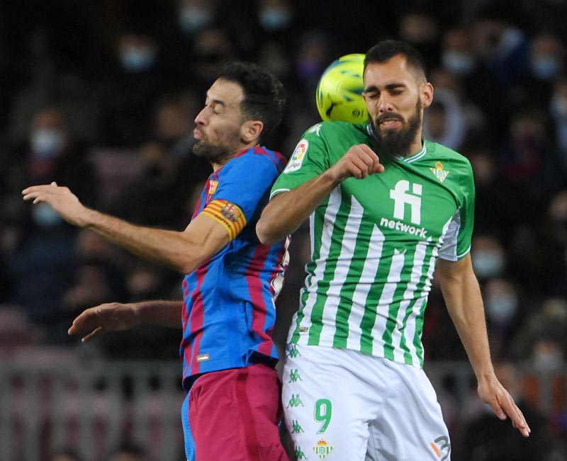 BARCELONA: Barcelona's Spanish midfielder Sergio Busquets (left) vies for a header with Real Betis' Spanish forward Borja Iglesias during the Spanish League football match between FC Barcelona and Real Betis yesterday. - AFP n