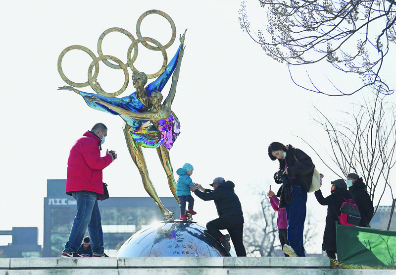 BEIJING: People walk past a statue with the Olympic Rings titled 'Dating With the Winter Olympics' by Huang Jian, near the headquarters of the Beijing Organizing Committee in Shougang Park, one of the sites for the Beijing 2022 Winter Olympics yesterday. - AFP n