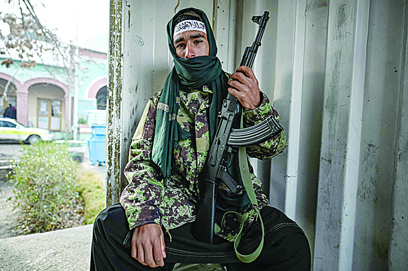 MAZAR-I-SHARIF, Balkh Province, Afghanistan: A Taleban fighter sits at a checkpoint in Mazar-i-Sharif.  —AFP