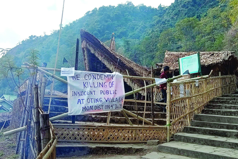  KOHIMA, India: A man walks behind a placard posted at the venue of the Hornbill festival which was shut after Indian security forces killed 13 civilians in the northeastern state of Nagaland firing on a truck and later shooting at a crowd that gathered to protest the attack, at Kisama village in Kohima yesterday. – AFPnn