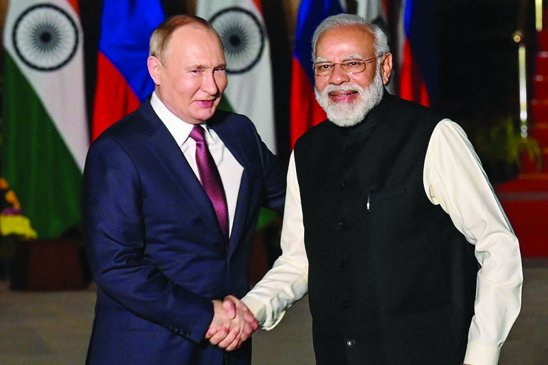 NEW DELHI: India's Prime Minister Narendra Modi (R) greets Russian President Vladimir Putin before a meeting at Hyderabad House in New Delhi yesterday. - AFPnn