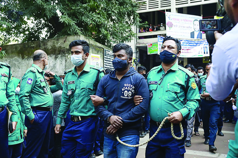 DHAKA: Police escort one of the 20 convicted university students, after their sentence to death for the brutal 2019 murder of a young man who criticised the government on social media, out of a court in Dhaka yesterday. – AFPnnn