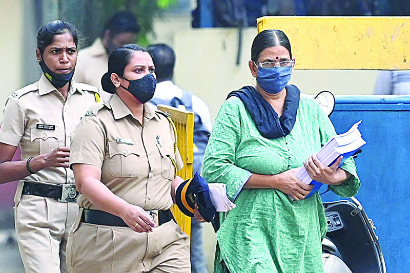 MUMBAI: Police escort activist Sudha Bharadwaj (right) towards a van as she leaves jail to appear in a special court ahead of her release on the 2018 Bhima Koregaon case in Mumbai. - AFP n