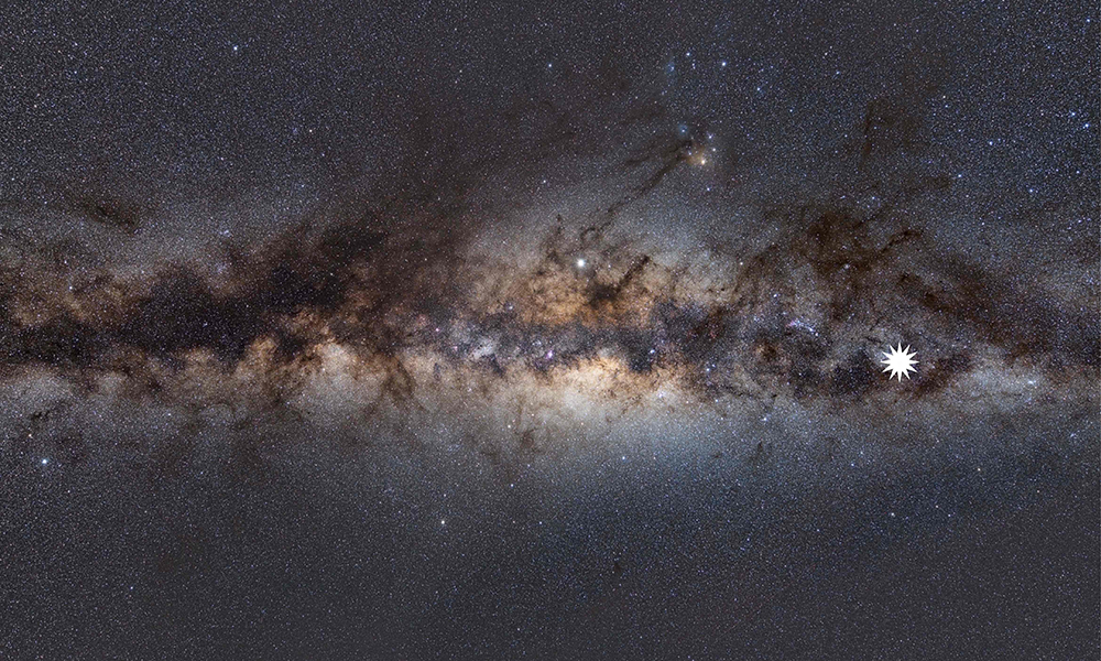 This undated handout image shows the Milky Way as viewed from Earth, with a star icon (at R-placed by source) marking the position of a mysterious repeating transient in space. — AFP