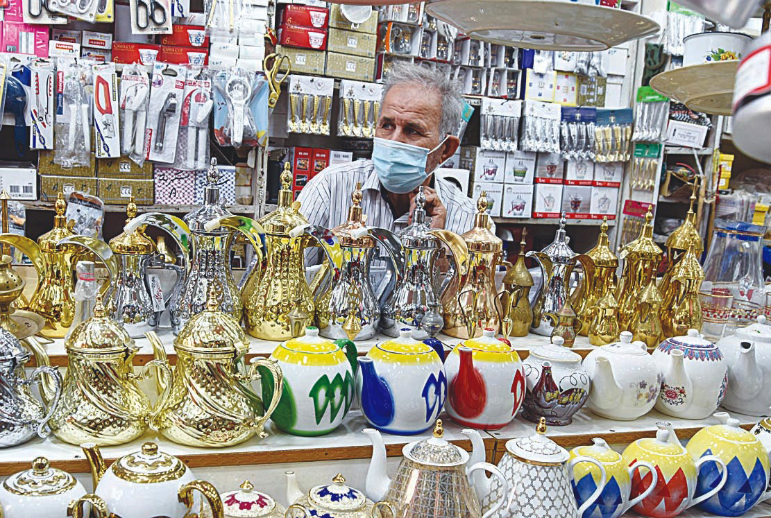 KUWAIT: This file photo shows a vendor siting inside his shop in Souq Mubarakiya in Kuwait City. This picture is used for illustrative purposes only. - Photo by Fouad Al-Shaikh