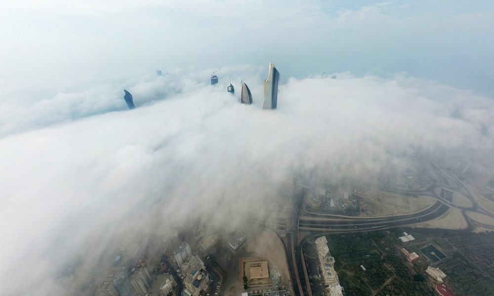 KUWAIT: A picture taken yesterday from the Al-Hamra Tower shows a view of Kuwait City under heavy fog. —Photo by Yasser Al-Zayyat