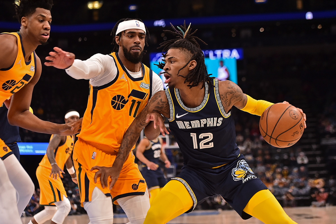 MEMPHIS: Ja Morant #12 of the Memphis Grizzlies drives the ball against Mike Conley #11 of the Utah Jazz during the first half at FedExForum on January 28, 2022 in Memphis, Tennessee. – AFP