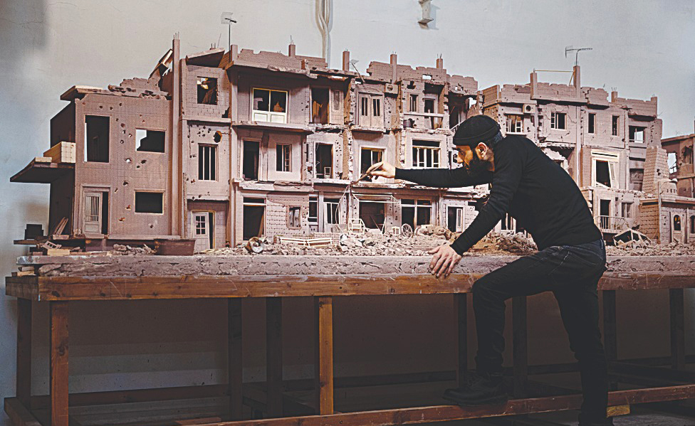Syrian sculptor Khaled Dawwa works on a clay artpiece.