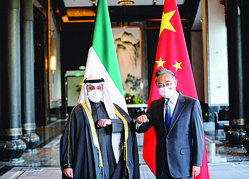 Kuwaiti Foreign Minister and State Minister for Cabinet Affairs Sheikh Dr Ahmad Nasser Al-Mohammad Al-Sabah and Chinese State Councilor and Foreign Minister Wang Yi. — KUNA