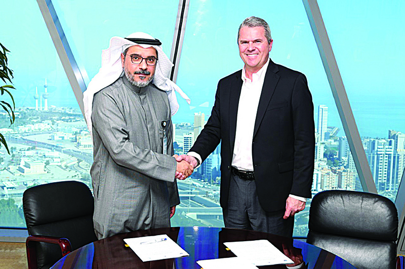 KUWAIT: Mohammad Al-Haimer, Acting CEO of KGOC (left) and Don Stilling, Senior Vice President of Chevron Saudi Arabia for Operations, shake hands after signing the agreement.  —KUNA