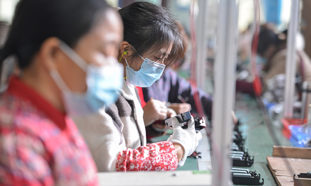 FUYANG, China: women working on an assembly line producing speakers at a factory in Fuyang in China’s eastern Anhui province. Factory activity in China edged down in January, official figures showed yesterday. — AFP