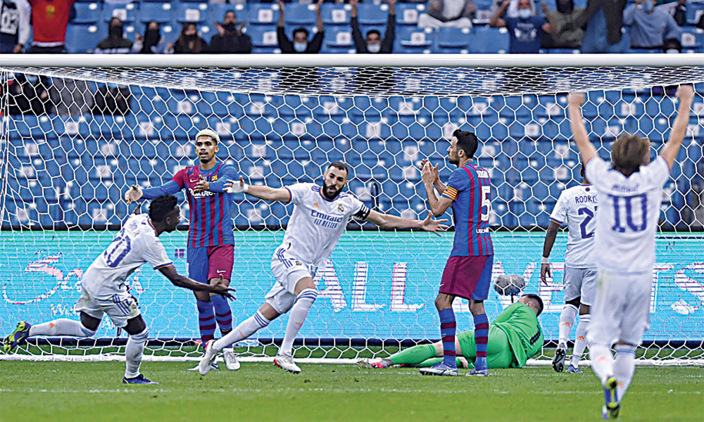RIYADH: Real Madrid’s French forward Karim Benzema (center) reacts after scoring during the Spanish Super Cup semi-final football match between Barcelona and Real Madrid at the King Fahad International stadium in the Saudi capital Riyadh on Wednesday. —AFP