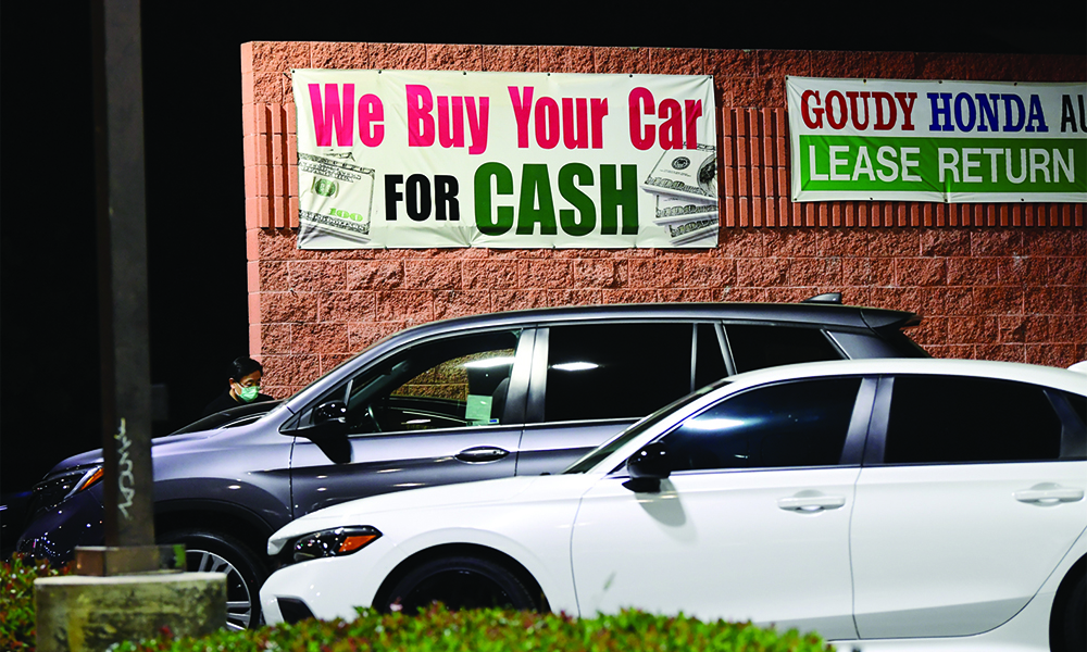 ALHAMBRA, US: A sign advertises cash paid for used cars in Alhambra, California Wednesday. — AFP