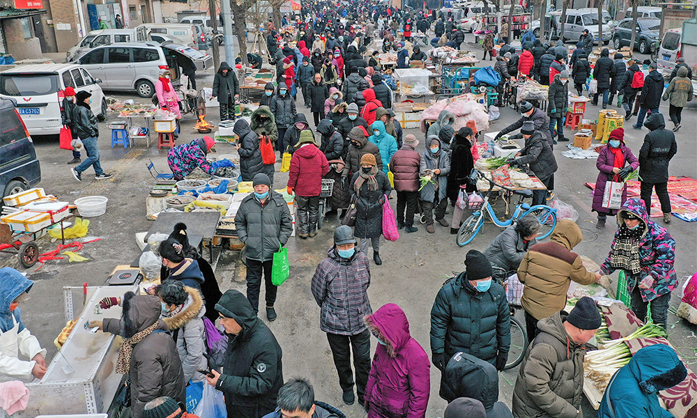SHENYANG, China: Residents visit a market in Shenyang in China’s northeastern Liaoning province yesterday. — AFP
