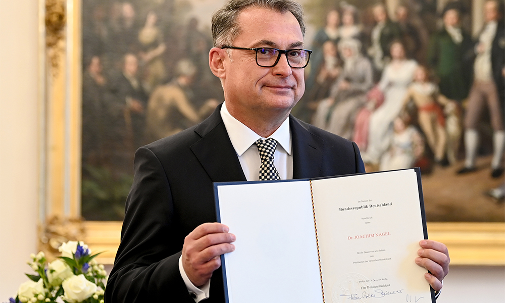 BERLIN: Incoming German Central Bank head Joachim Nagel poses with his certificate of appointment presented to him by German President Frank-Walter Steinmeier (not in picture) at the presidential Bellevue palace in Berlin.— AFP