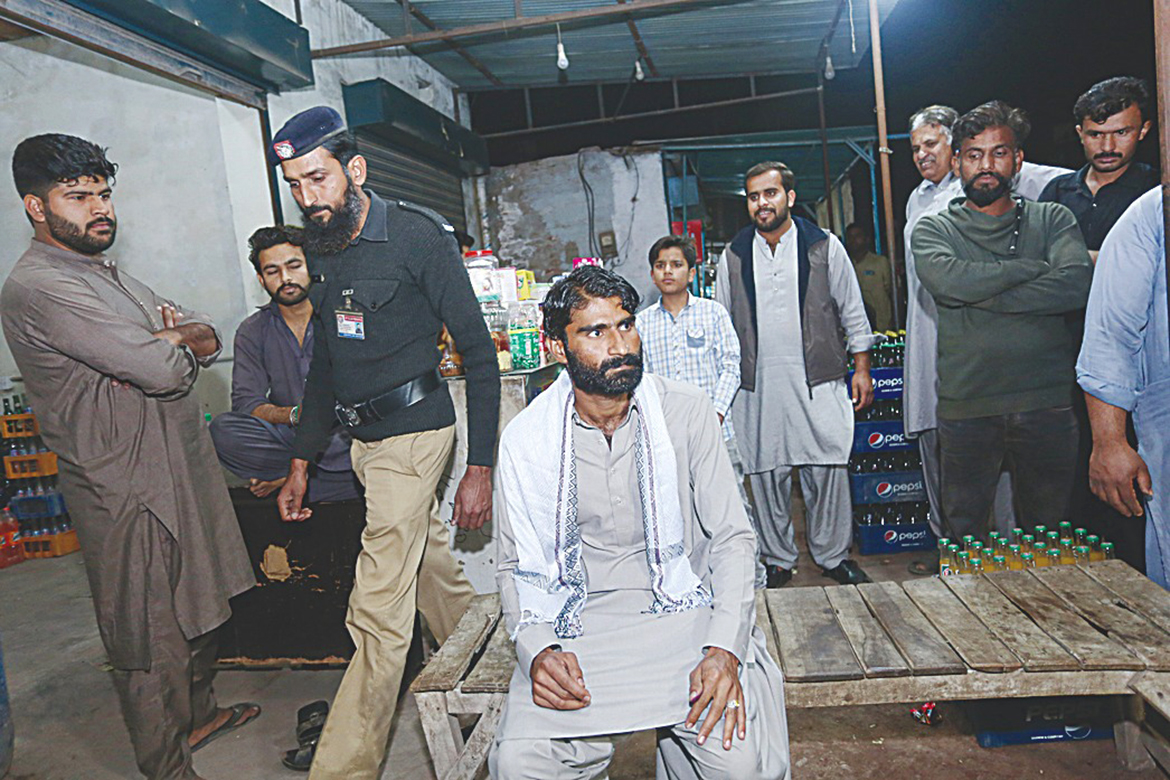 MULTAN: Muhammad Waseem (C), the brother of slain social media celebrity Qandeel Baloch, sits outside a shop after he was freed from jail in Multan. – AFP