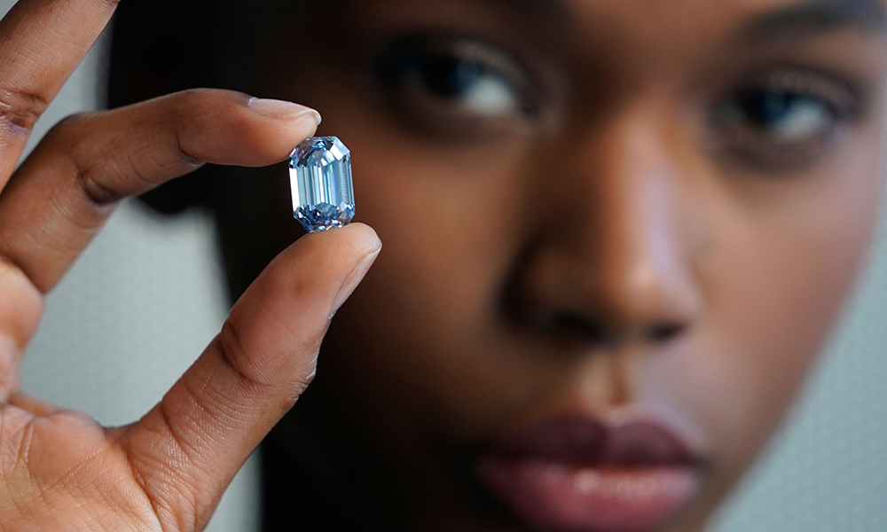 In this file photo Model Stephany Martins holds up the “The De Beers Cullinan Blue” blue diamond during a press preview at Sotheby’s in New York. — AFP