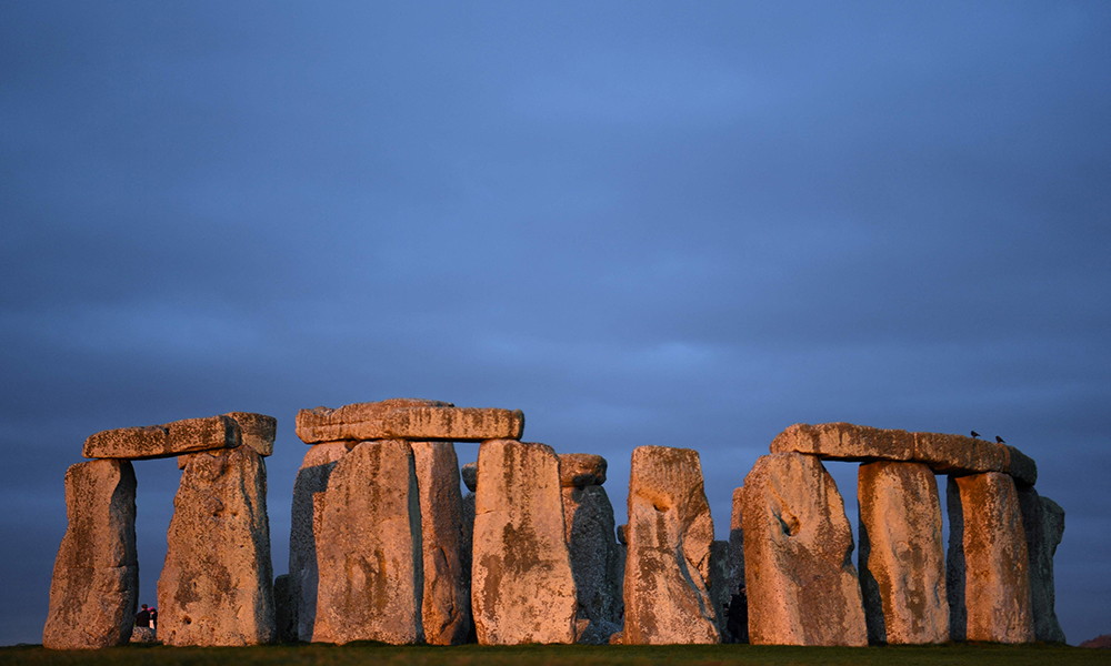 The sun rises at the prehistoric monument Stonehenge near Amesbury in southern England.—AFP photos