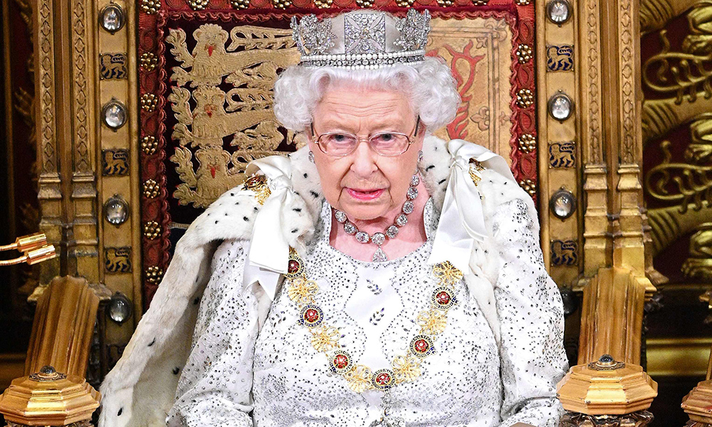 In this file photo Britainís Queen Elizabeth II sits on the Sovereignís throne in the House of Lords as she delivers the Queenís Speech at the State Opening of Parliament in the Houses of Parliament in London.