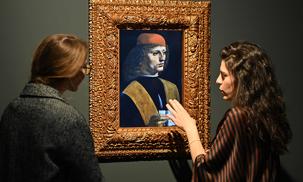 People look at a digital reproduction of ‘Ritratto di Musico (Portrait of a Musician)’, by Leonardo da Vinci, displayed as part of the ‘Eternalising Art History: From Da Vinci to Modigliani’ exhibition at the Unit London gallery in London. — AFP photos