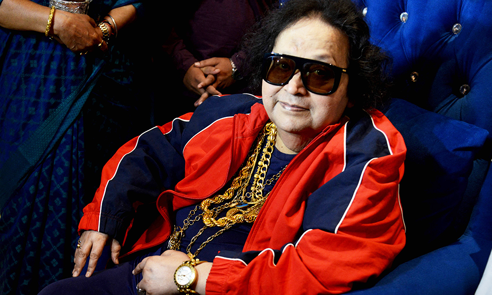 In this file photo Bollywood singer, music composer Bappi Lahiri interacts with the media before planting a tree during an environment awareness campaign in Mumbai. — AFP