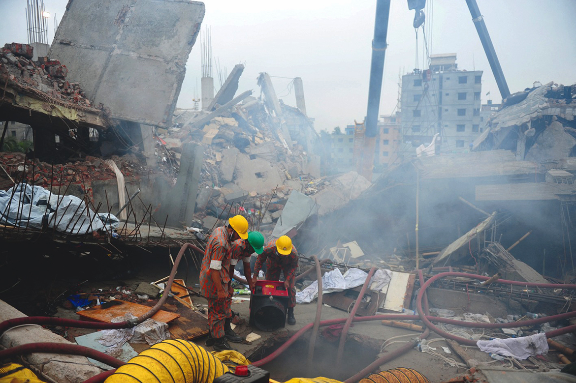 SAVAR: File photo shows, Bangladeshi firefighters try to control a blaze during a rescue attempt as Bangladeshi Army personnel begin the second phase of the rescue operation following the Rana Plaza building collapsed in Savar, on the outskirts of Dhaka. - AFP