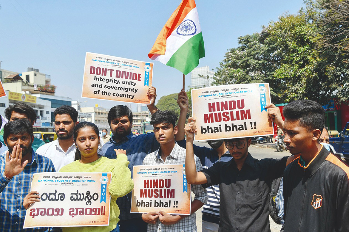 BANGALORE: Activists from the National Students Unions of India hold placards and Indian flags during a demonstration yesterday. - AFP