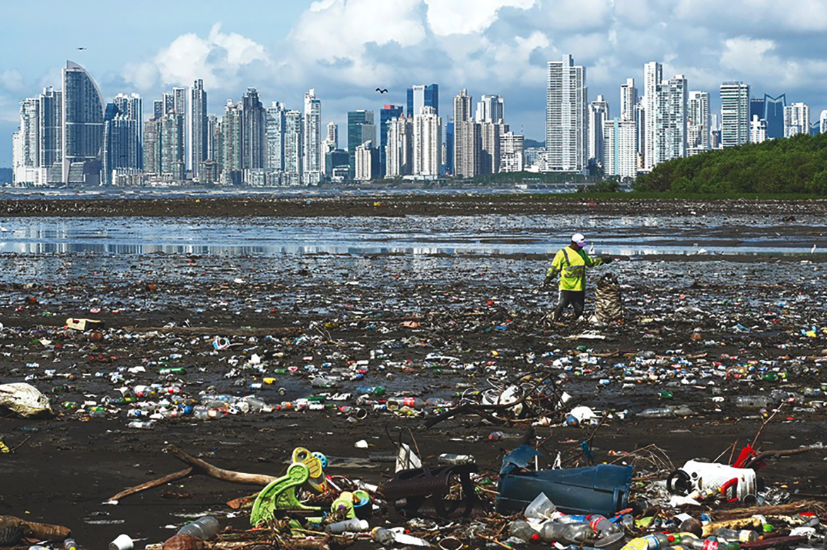 PANAMA CITY: In this file photo,  a man collects garbage, including plastic waste, at the beach of Costa del Este, in Panama City. - AFP