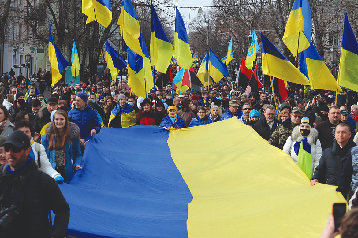 ODESSA, Ukraine: Protesters carry a giant Ukrainian flag during a rally to show unity and support of Ukrainian integrity amid soaring tensions with Russia yesterday. - AFP