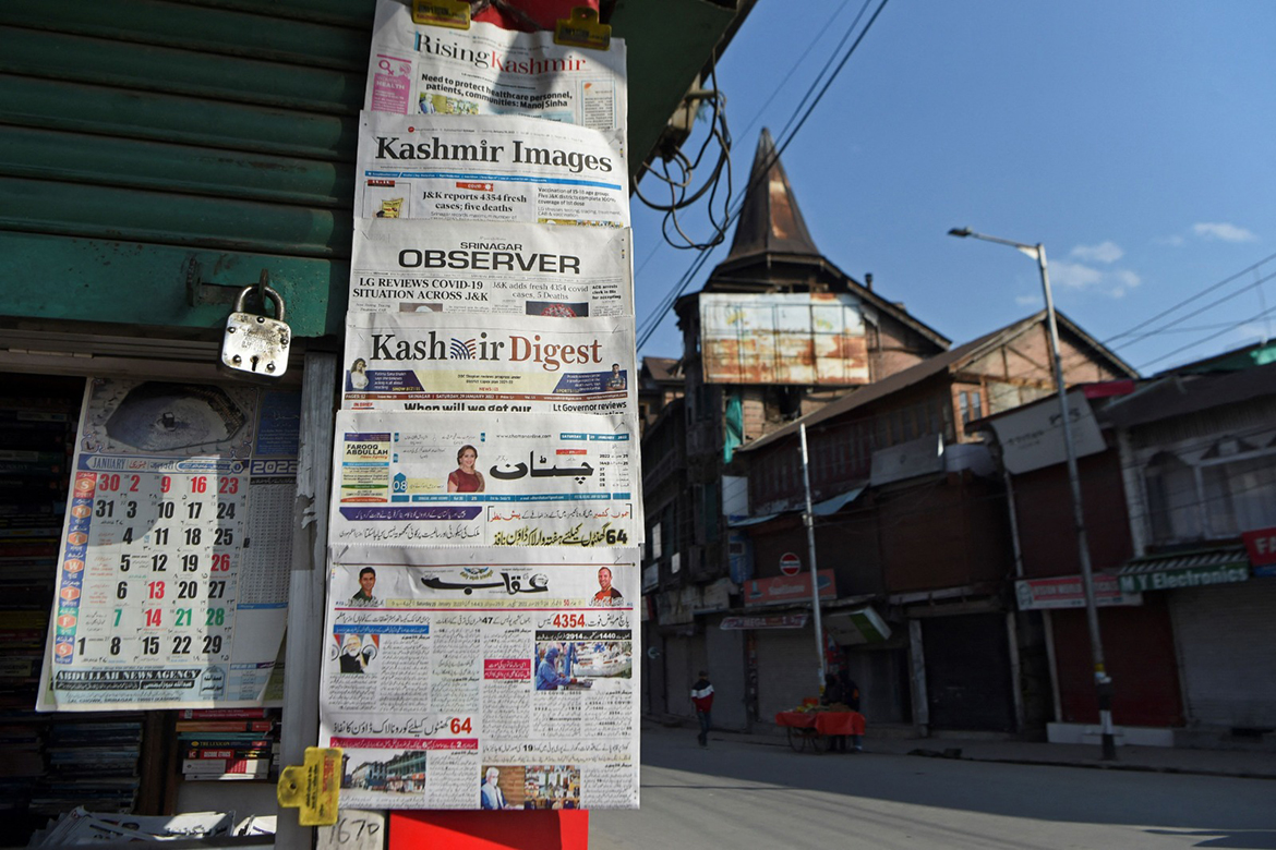 Local newspapers hang from a newsstand in Srinagar. - AFP