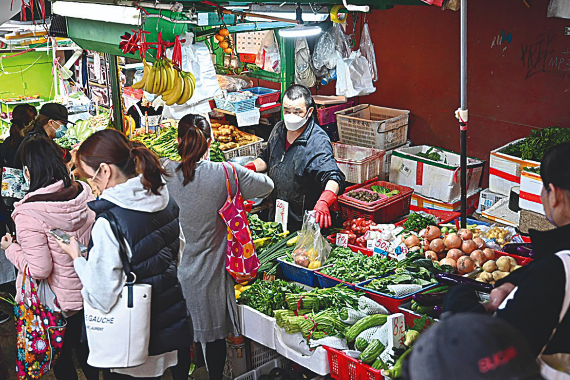 HONG KONG: Shoppers buy vegetables a day after many shops ran out of some produce in Hong Hong, as stricter COVID-19 restrictions come into force following the city's highest infection numbers since the pandemic began. - AFP