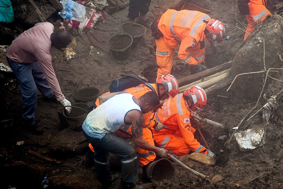 PETROPOLIS, Brazil: Rescue workers search for victims after a giant landslide in Petropolis, Brazil yesterday. - AFP