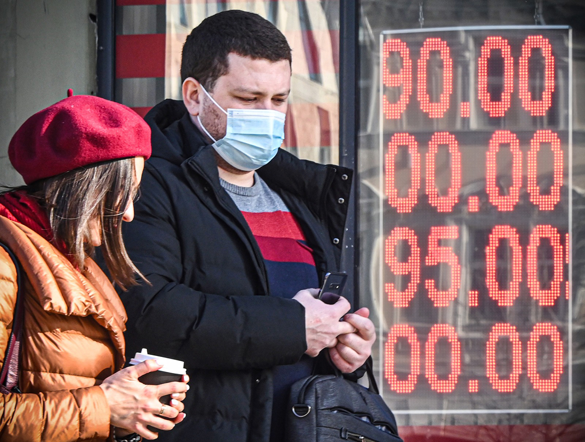 MOSCOW: People walk past a currency exchange office in central Moscow yesterday with zeros on the scoreboard since there are no three-digit sections on it to display the current exchange rate. - AFP