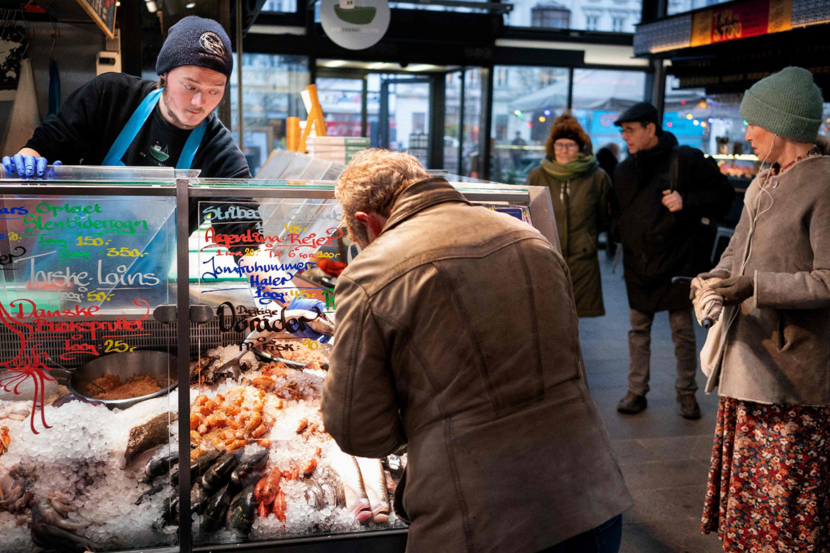 COPENHAGEN: Customers are pictured at the fish market in Torvehallerne on February 1, 2022, as Denmark becomes the first EU country to lift coronavirus restrictions despite record case numbers, citing its high vaccination rates and the lesser severity of Omicron variant. - AFP
