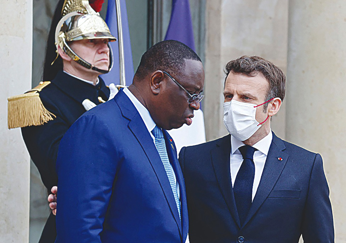 PARIS: France's President Emmanuel Macron (R) speaks with Senegal's President Macky Sall prior to a meeting on the Sahel at The Elysee Presidential Palace in Paris yesterday. - AFP