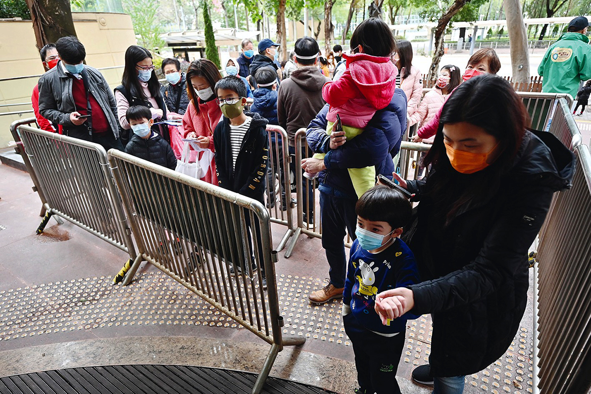 HONG KONG: People queue up for COVID-19 tests outside a community vaccination centre especially for children and the elderly in Hong Kong yesterday, as the city faces its worst coronavirus wave to date. - AFP