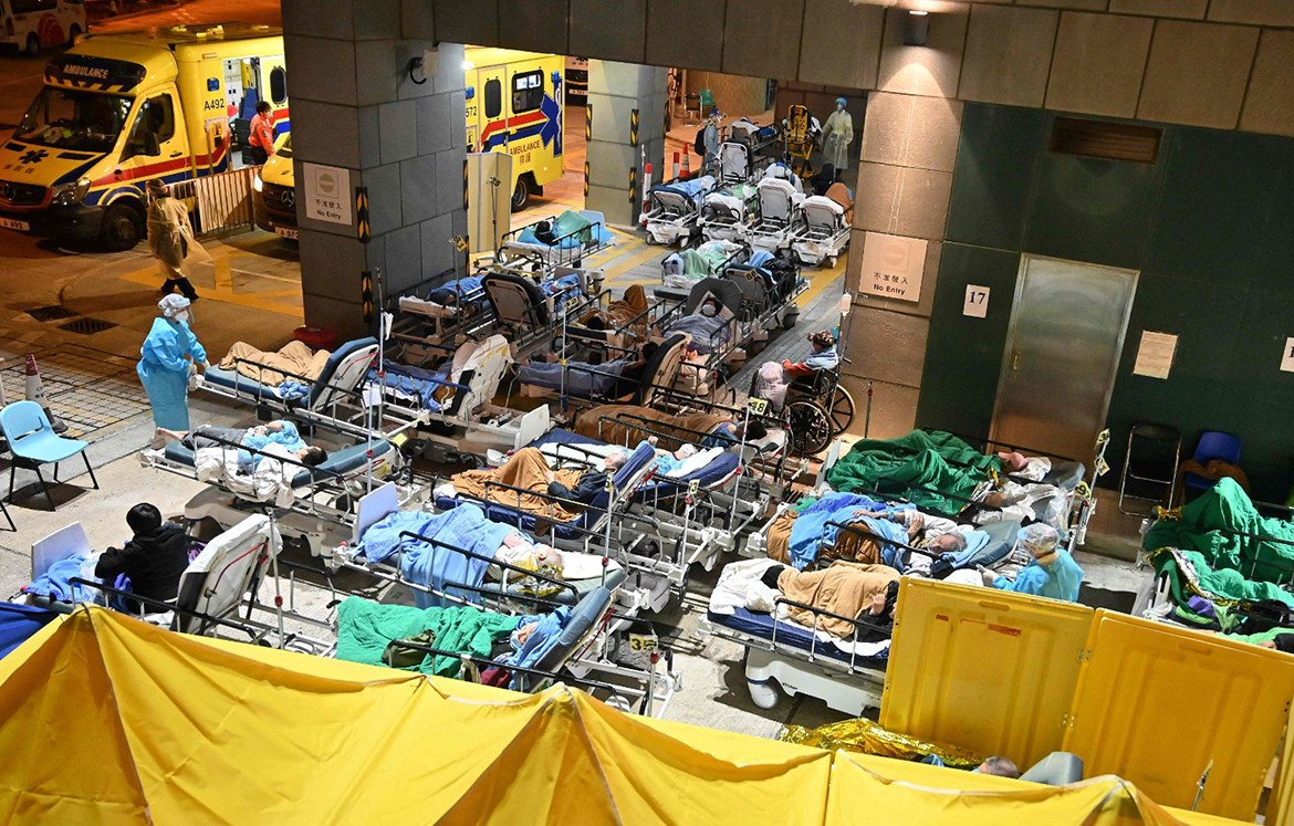 HONG KONG: People lie in hospital beds with temperatures falling at nighttime outside the Caritas Medical Centre in Hong Kong yesterday, as hospitals become overwhelmed with the city facing its worst COVID coronavirus wave to date.  – AFP