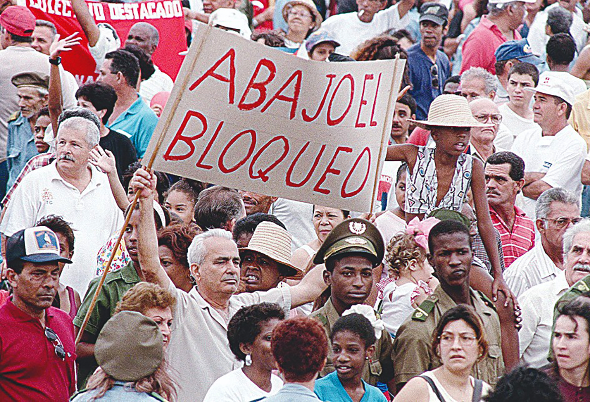 HAVANA: File photo shows a worker holds up a sign condemning the US economic embargo against the communist nation during the traditional Labor Day parade in downtown Havana. February 7, 2022 commemorates de 60th anniversary of the embargo imposed by the US to Cuba. - AFP