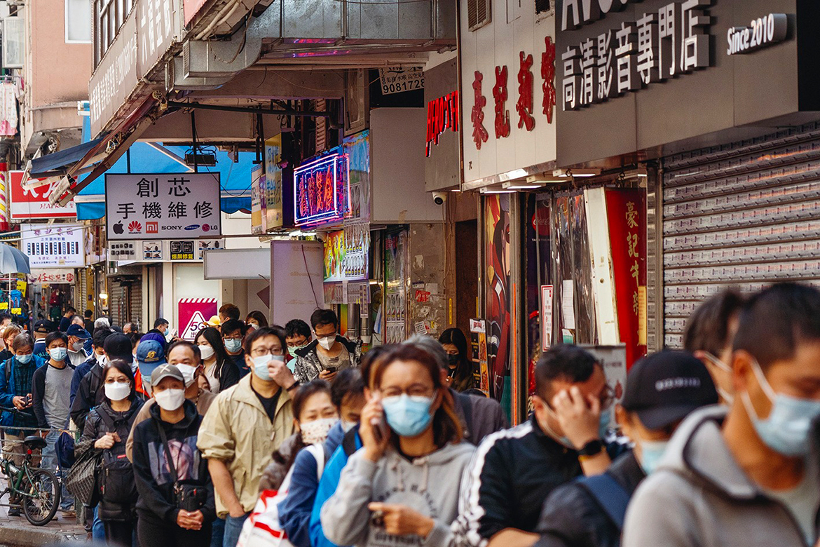 HONG KONG: People queue on a street for Covid-19 test kits in Hong Kong's Sham Shui Po area as yet another record high number of new COVID-19 infections were recorded in the city.-AFP