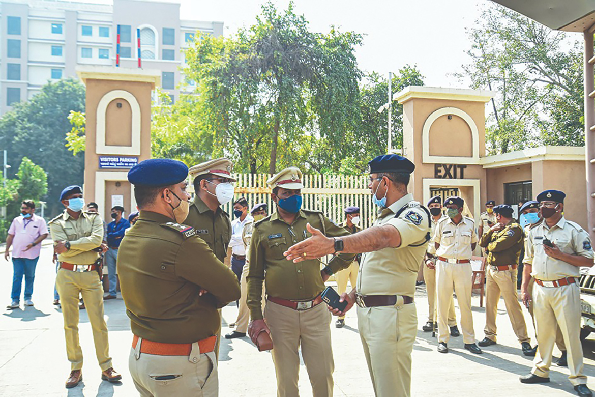 AHMEDABAD, Gujarat: Police stand outside a sessions court in Ahmedabad yesrerday during a court hearing for 2008 bomb attacks in India's Gujarat state. – AFP