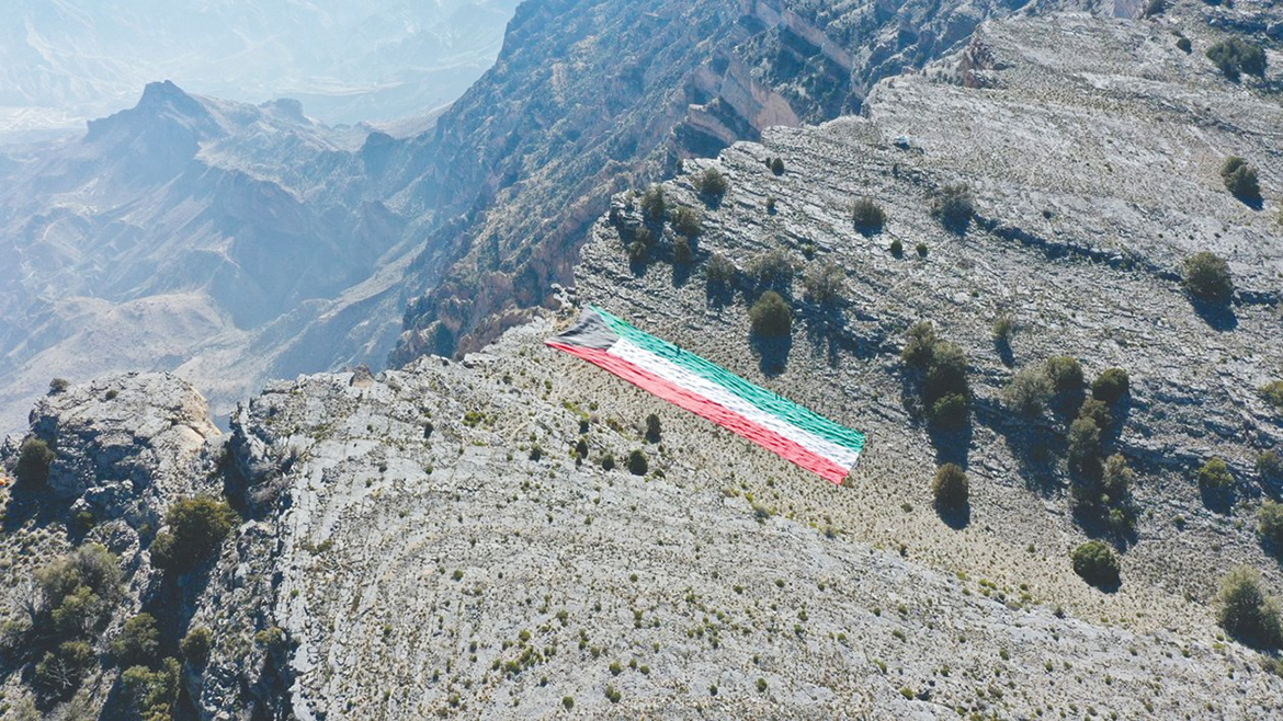 A 2,742-sq-m Kuwaiti flag is unfurled on the summit of Oman's Jebel Shams.