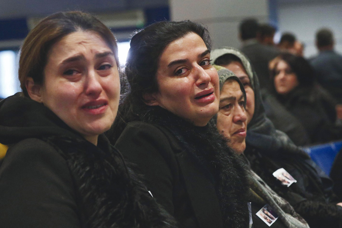 ARBIL, Iraq: Women, relatives of five Kurdish migrants who died a month prior as their boat capsized while attempting a crossing of the Aegean Sea, react as they await the arrival of the remains at Arbil airport in the capital of Iraq's northern autonomous Kurdish region on February 1, 2022.  - AFP