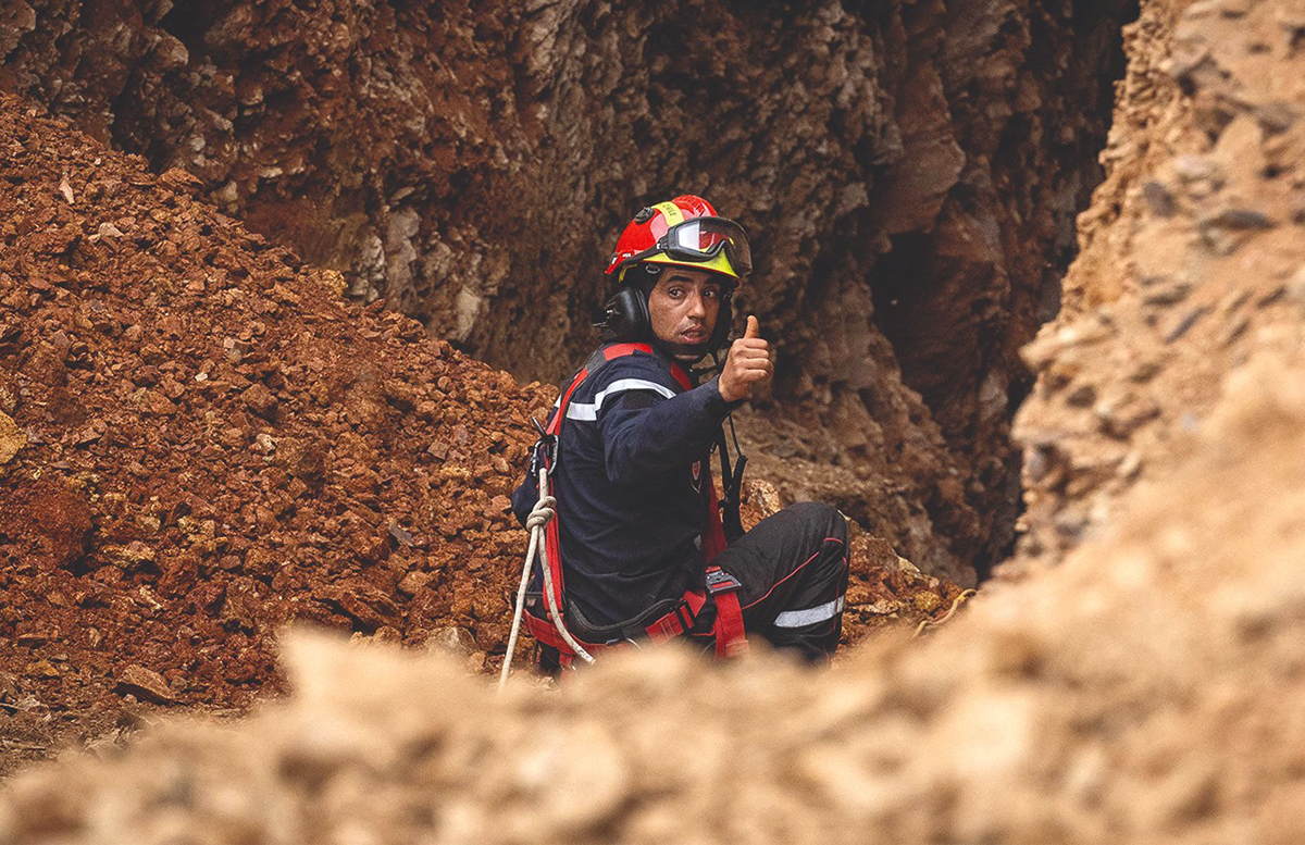 IGHRANE, Morocco: A member of the Moroccan emergency services gestures as teams work yesterday on the rescue of five-year-old boy Rayan from a well shaft he fell into in this remote village. - AFP