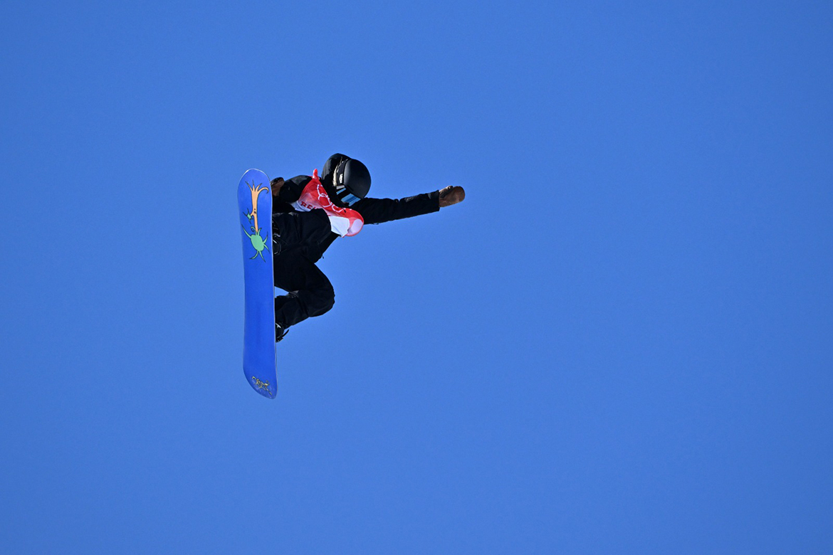 ZHANGJIAKOU: New Zealand's Zoi Sadowski Synnott competes in the snowboard women's slopestyle final run during the Beijing 2022 Winter Olympic Games at the Genting Snow Park H & S Stadium yesterday. (Inset) Gold medalist Sadowski Synnott celebrates on the podium. – AFP