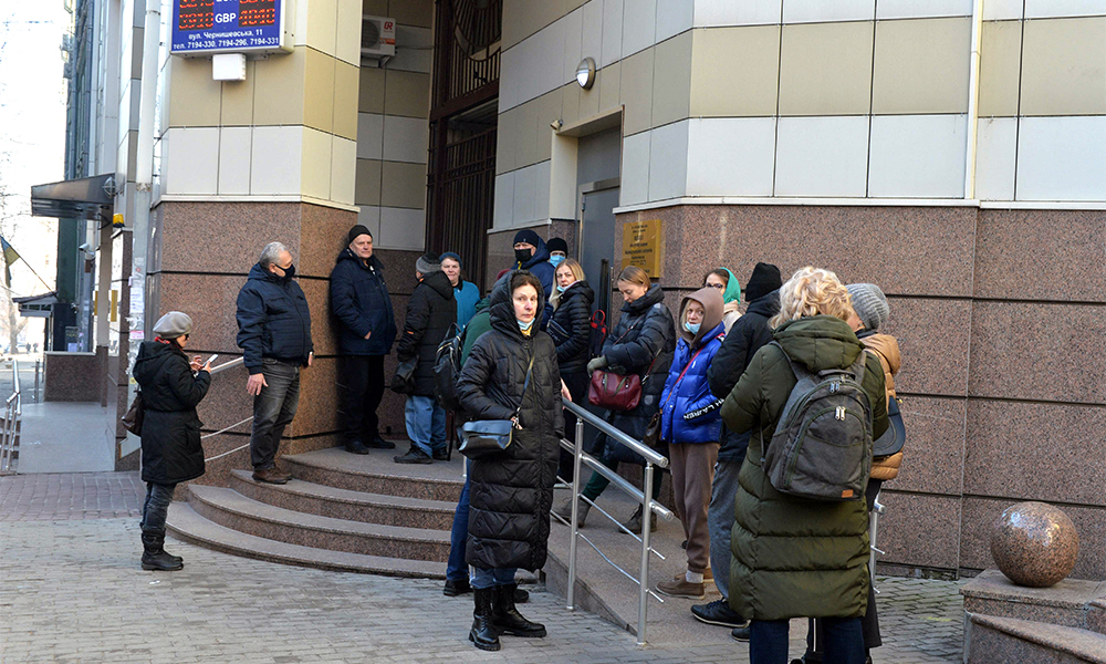KHARKIV: People queue outside a bank office in Kharkiv yesterday. Russian President Vladimir Putin announced a military operation in Ukraine yesterday with explosions heard soon after across the country and its foreign minister warning a ‘full-scale invasion’ was underway. — AFP