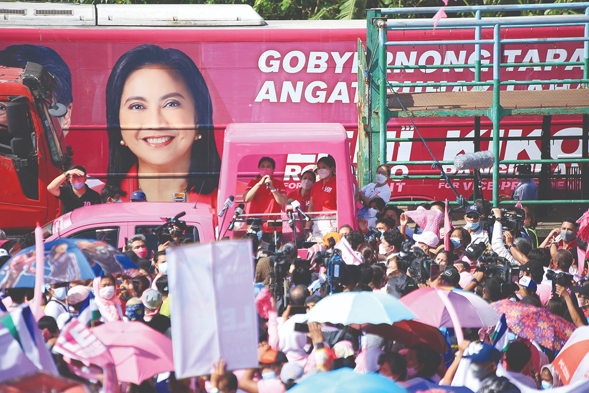 LIBMANAN: Philippine Vice President and opposition presidential candidate Leni Robredo (center-with microphone) speaks from a truck during a campaign rally in the town of Libamanan, Camarines Sur province, south of Manila yesterday, as candidates hit the road for the start of the three-month long campaign season. - AFP