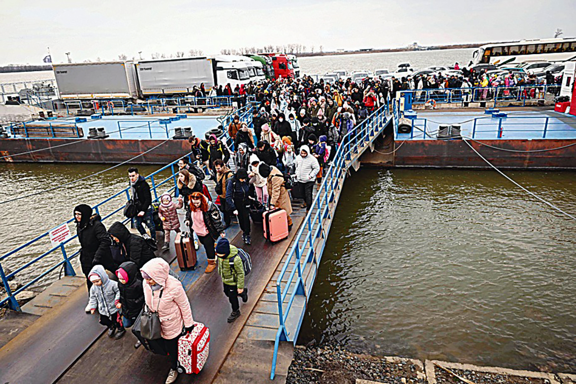 ISACCEA, Romania :  People coming from Ukraine descend from a ferry boat to enter Romania after crossing the Danube river at the Isaccea-Orlivka border crossing between Romania and Ukraine as Ukrainians flee their country following Russia’s invasion of Ukraine. — AFP
