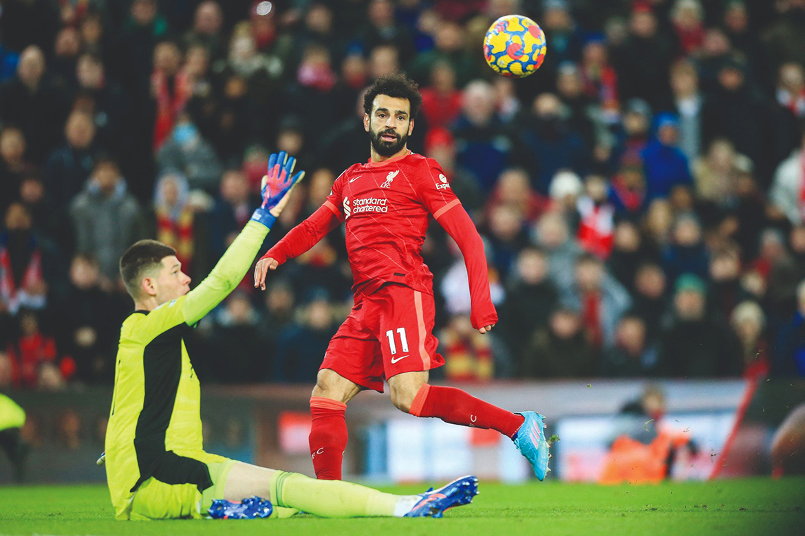 LIVERPOOL: Liverpool's Egyptian midfielder Mohamed Salah eyes the ball as he fights for it with Leeds United's French goalkeeper Illan Meslier (left) during the English Premier League football match between Liverpool and Leeds at the Anfield stadium on February 23, 2022. - AFP