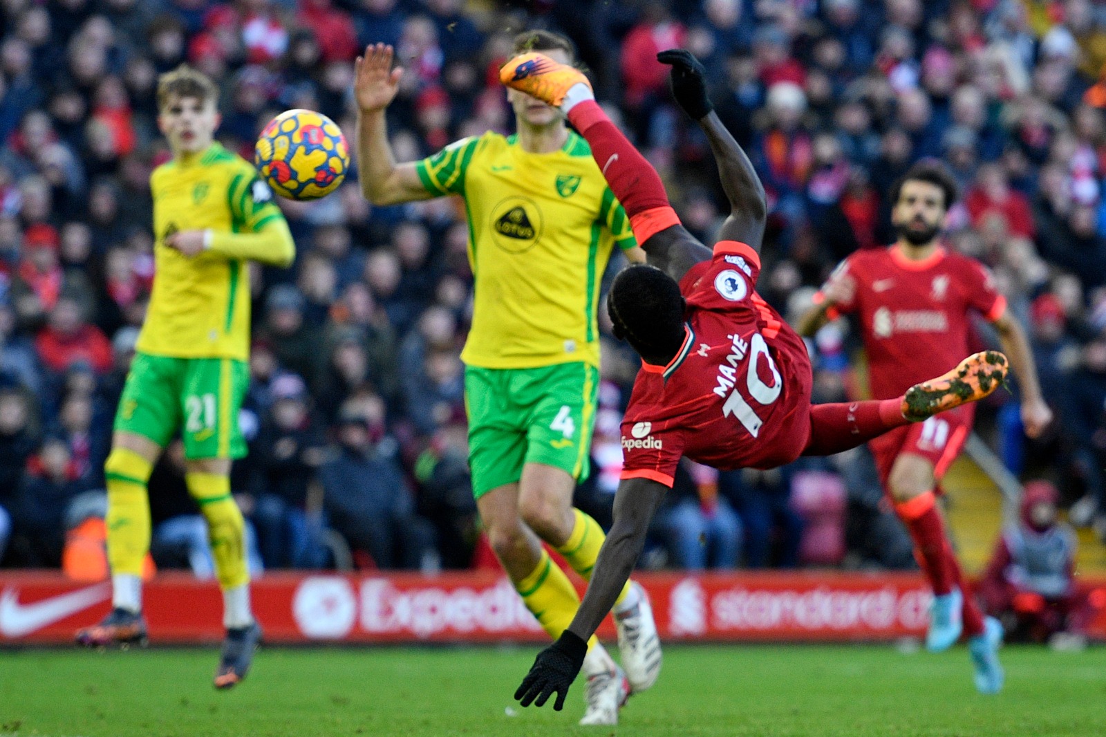 LIVERPOOL: Liverpool's Senegalese striker Sadio Mane scores their first goal with this acrobatic shot during the English Premier League football match between Liverpool and Norwich City yesterday.- AFP